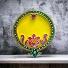 yellow decorative wooden thali for pooja on table top