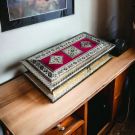 rectangular meenakari dryfruit box placed on side table