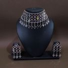 silver mirror jewellery set in mannequin on brown background