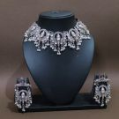 silver ganesha necklace set in mannequin on brown background