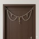 pearl toran hanging on teak brown main door 