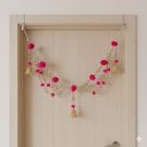 layered golden bead and pink pompom toran 