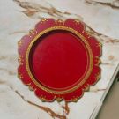 red large wooden pooja thali placed on table