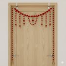 red pompom toran with door side hangings on ivory door frame