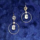 round rose gold dangler earrings on dark blue velvet 