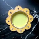 yellow pooja thali on black marble countertop