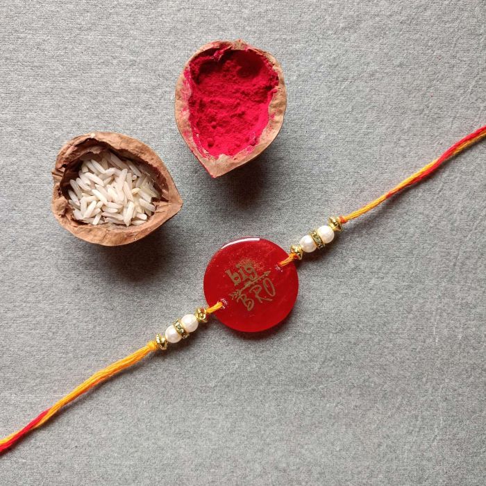 Red round resin rakhi - Big Bro with roli chawal pack
