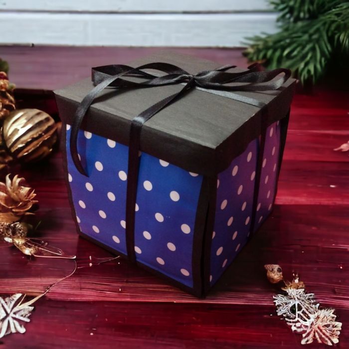 explosion gift box - blue & black - placed on table closed 