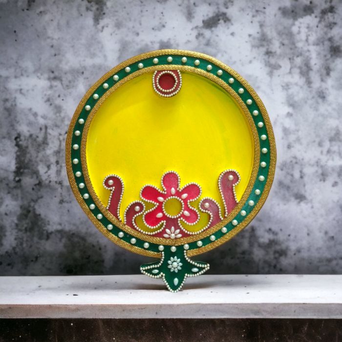 yellow decorative wooden thali for pooja on table top 