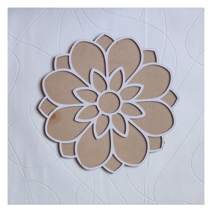 floral MDF rangoli stencil placed on white sheet