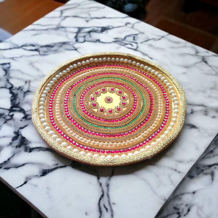 decorated stainless steel thali for pooja placed on table