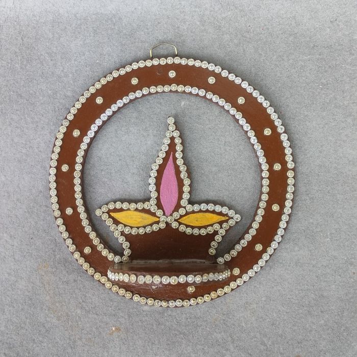 brown colored diya shaped wall mounted diya stand 
