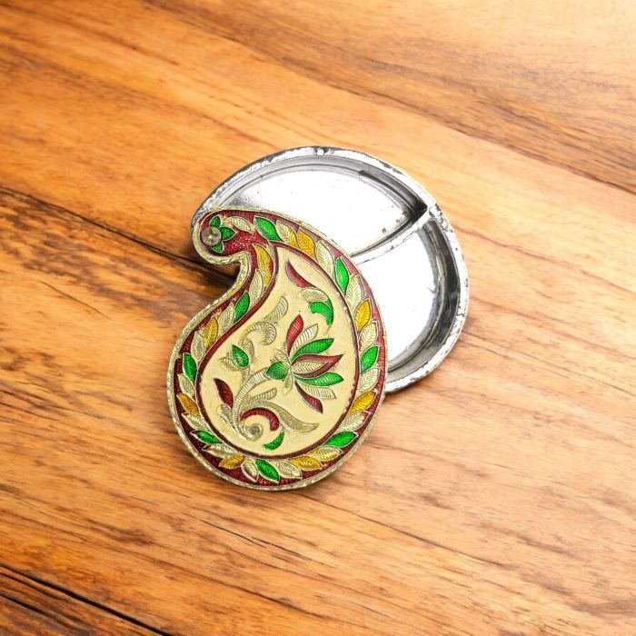 paisley shaped haldi kumkum box - open placed on wooden countertop