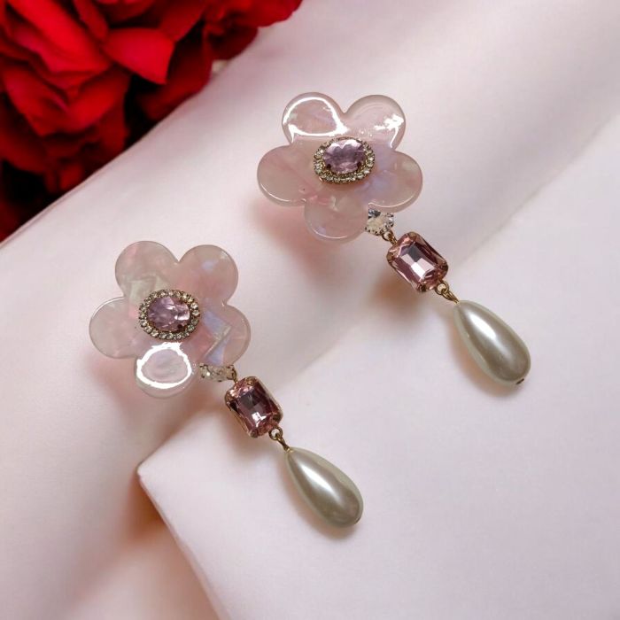 pink flower drop earrings on pink background
