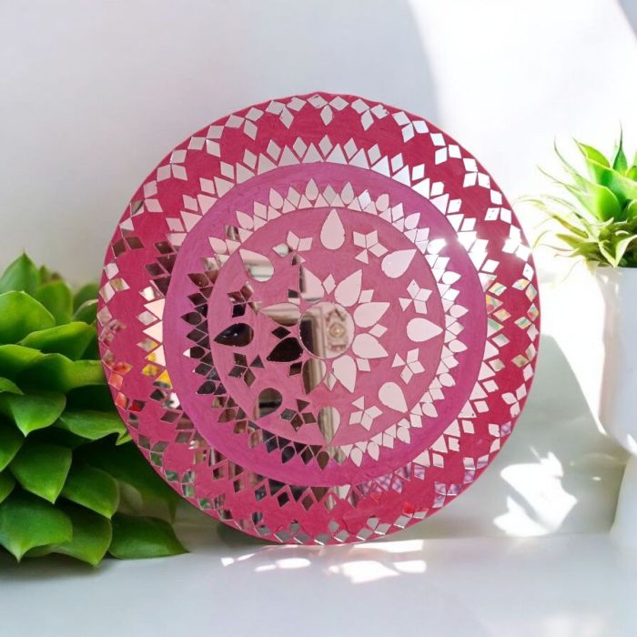 pink mosaic art work placed against the wall 