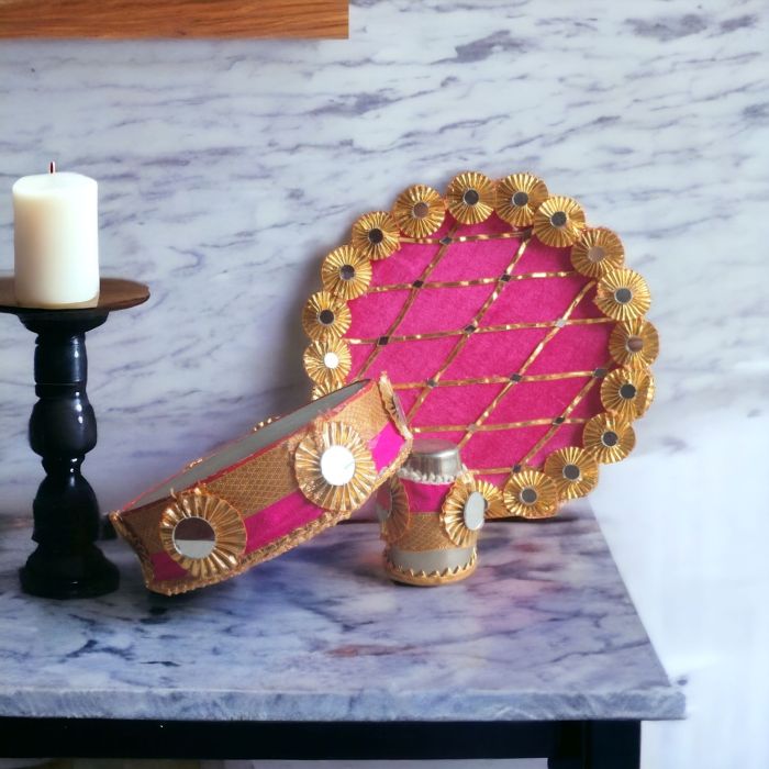 karwa chauth thali set pink colour designed with gota and mirror work placed on marble countertop