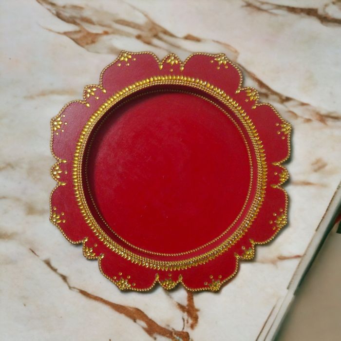 red large wooden pooja thali placed on table