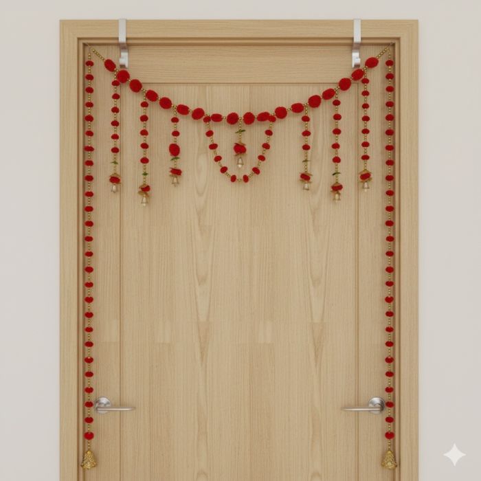 red pompom toran with door side hangings on ivory door frame