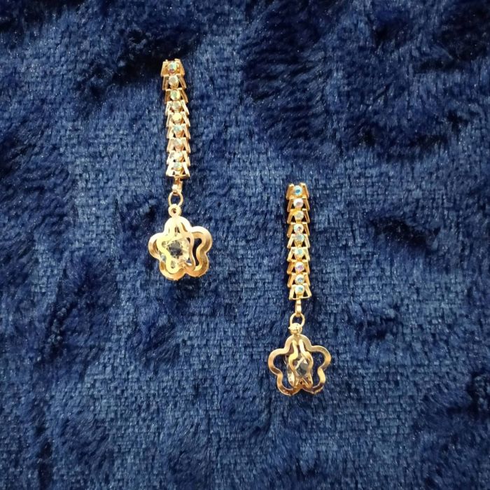 rose gold linear dangle and drop earrings on dark blue velvet