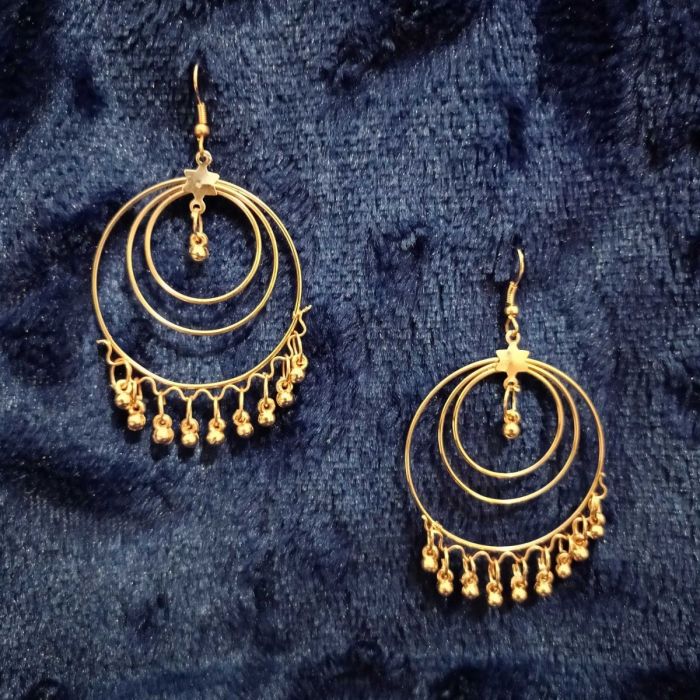 rose good hoop earrings placed on dark blue fabric