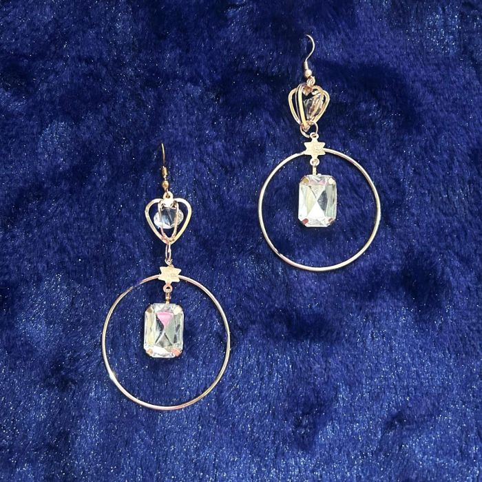 round rose gold dangler earrings on dark blue velvet 