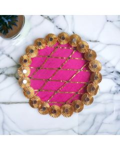 pink gota and mirror work stainless steel decorative pooja thali placed on marble countertop - top view