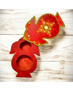 open kalash shaped haldi kumkum box placed on light wood counter top