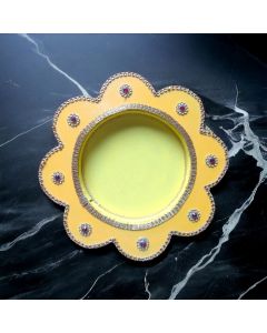 yellow pooja thali on black marble countertop