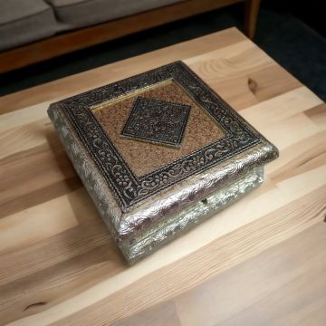 square meenakari dryfruit box placed on table top