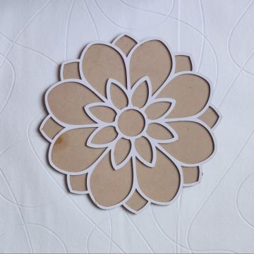 floral MDF rangoli stencil placed on white sheet