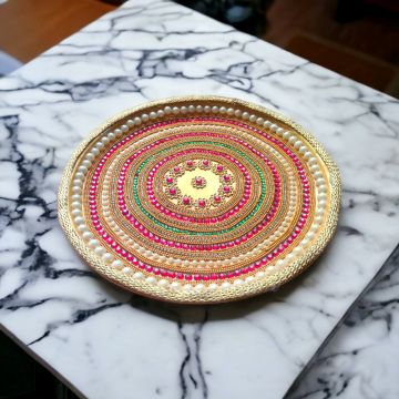 decorated stainless steel thali for pooja placed on table