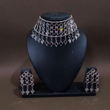 silver mirror jewellery set in mannequin on brown background