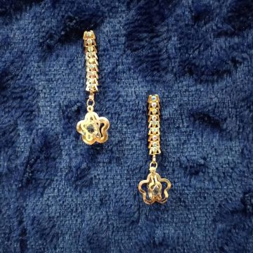 rose gold linear dangle and drop earrings on dark blue velvet