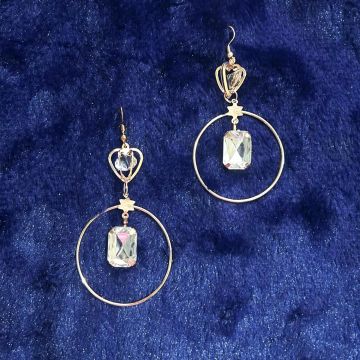 round rose gold dangler earrings on dark blue velvet 