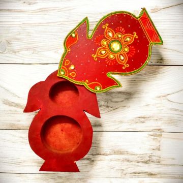 open kalash shaped haldi kumkum box placed on light wood counter top